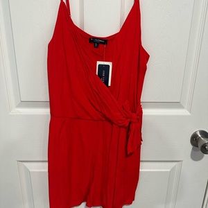 Romper is in the color light red and was never worn still has a tag